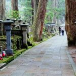 The walking path through Okunoin Cemetery at Koyasan, with a couple of people walk ahead
