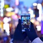 person holding phone, staying connected is important when overseas, here's where to find internet in Japan as a tourist.