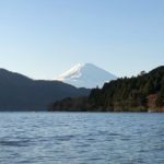 Lake Ashinoko in Kanagawa Prefecture, with a snow capped Mount Fuji Behind and the Torii of Hakone Shrine on the lake's edge