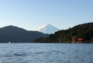 Lake Ashinoko in Kanagawa Prefecture, with a snow capped Mount Fuji Behind and the Torii of Hakone Shrine on the lake's edge